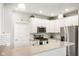 Bright kitchen with white cabinets, stainless steel appliances, and a subway tile backsplash at 8842 Twain Ln, Indianapolis, IN 46239