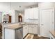 Bright kitchen featuring white cabinets, stainless steel appliances, and hardwood flooring at 8842 Twain Ln, Indianapolis, IN 46239