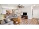 Open concept living room featuring hardwood floors, a gray sofa, and neutral walls at 8842 Twain Ln, Indianapolis, IN 46239