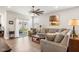 Bright living room with a plush sofa, decorative accents, and sliding glass doors leading to the outdoors at 8842 Twain Ln, Indianapolis, IN 46239