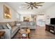 Open living space with a large sectional sofa, hardwood floors, and views into the kitchen at 8842 Twain Ln, Indianapolis, IN 46239