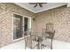 Covered patio with brick walls, ceiling fan, glass top table, and metal chairs at 8842 Twain Ln, Indianapolis, IN 46239