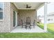 Brick patio with a ceiling fan and outdoor furniture overlooking the backyard at 8842 Twain Ln, Indianapolis, IN 46239