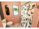 Charming bathroom with black and white tile, a floral wall hanging, and a shower with a modern curtain at 972 N Audubon Rd, Indianapolis, IN 46219