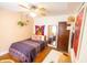 Bright bedroom with ceiling fan, unique wall decor, and decorative throw blanket at 972 N Audubon Rd, Indianapolis, IN 46219