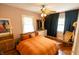 Bright bedroom features a ceiling fan, hardwood flooring and stylish decor at 972 N Audubon Rd, Indianapolis, IN 46219