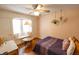 Cozy bedroom featuring built-in window seat, ceiling fan and hardwood floors at 972 N Audubon Rd, Indianapolis, IN 46219