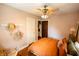 Cozy bedroom featuring ceiling fan, hardwood floors and calming paint colors at 972 N Audubon Rd, Indianapolis, IN 46219