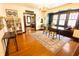 Open dining room with hardwood floors, area rug, and window seat at 972 N Audubon Rd, Indianapolis, IN 46219