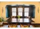 Cozy dining room with built-in window seat and decorative leaded glass windows at 972 N Audubon Rd, Indianapolis, IN 46219