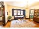 Spacious dining room with chandelier, natural light, and hardwood floors at 972 N Audubon Rd, Indianapolis, IN 46219