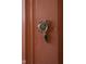 Elegant vintage glass doorknob set against a peach colored door at 972 N Audubon Rd, Indianapolis, IN 46219