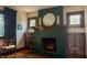 Charming fireplace with green tiles, custom cabinets, and period lighting at 972 N Audubon Rd, Indianapolis, IN 46219