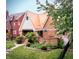 Inviting brick home with a stylish metal roof, cozy front patio, and lush garden bed at 972 N Audubon Rd, Indianapolis, IN 46219