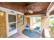 Inviting covered porch with comfortable chairs, a ceiling fan, and classic brickwork at 972 N Audubon Rd, Indianapolis, IN 46219