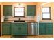 Charming kitchen features painted cabinets, stainless steel dishwasher, and a sink under a window at 972 N Audubon Rd, Indianapolis, IN 46219