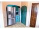 Spacious kitchen with stainless steel refrigerator, traditional cabinets, and tiled floors at 972 N Audubon Rd, Indianapolis, IN 46219