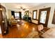 Comfortable living room with hardwood floors, a fireplace, and bright windows at 972 N Audubon Rd, Indianapolis, IN 46219