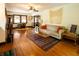 Bright living room with hardwood floors, decorative rug, and ample natural light at 972 N Audubon Rd, Indianapolis, IN 46219
