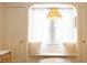 Charming window seat nestled between two doors, filled with light and comfy pillows at 972 N Audubon Rd, Indianapolis, IN 46219