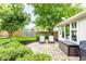 Charming backyard with brick patio, lush landscaping, and seating, perfect for outdoor entertaining at 9740 Logan Ln, Fishers, IN 46037