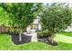 Secluded backyard with mature trees, brick patio, storage, and inviting outdoor seating area at 9740 Logan Ln, Fishers, IN 46037
