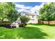 Expansive backyard featuring a brick patio, lush lawn, privacy fence, and mature trees at 9740 Logan Ln, Fishers, IN 46037