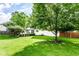 Well-maintained backyard with lush greenery, mature trees, and a cozy outdoor seating area at 9740 Logan Ln, Fishers, IN 46037