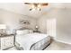Bedroom featuring neutral walls, ceiling fan, and a cozy bed with decorative pillows at 9740 Logan Ln, Fishers, IN 46037