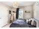 Bedroom showcasing woven pendant lighting, a bed, and minimal decor at 9740 Logan Ln, Fishers, IN 46037