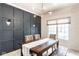 Stylish dining room featuring a modern light fixture, gray paneled wall, and patterned wallpaper at 9740 Logan Ln, Fishers, IN 46037