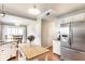 Open kitchen layout with stainless steel appliances, granite countertops, a center island, and hardwood floors at 9740 Logan Ln, Fishers, IN 46037