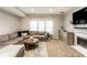 Relaxing living room with a sectional sofa, fireplace, large window, and stylish decor at 9740 Logan Ln, Fishers, IN 46037