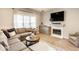Comfortable living room with a sectional sofa, fireplace, and stylish decor at 9740 Logan Ln, Fishers, IN 46037