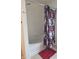 Bathroom features a jacuzzi tub, with a shower with red flower-patterned curtain at 10523 Dark Star Dr, Indianapolis, IN 46234