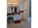 Bathroom features a vanity with a black countertop and red brick backsplash, with modern lighting fixtures at 10523 Dark Star Dr, Indianapolis, IN 46234