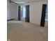 A bedroom with light walls, carpeted floor, windows with curtains, and a ceiling fan at 10523 Dark Star Dr, Indianapolis, IN 46234