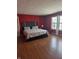 A primary bedroom with red walls and hardwood floors at 10523 Dark Star Dr, Indianapolis, IN 46234