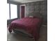 Bedroom featuring large windows and a stone accent wall at 10523 Dark Star Dr, Indianapolis, IN 46234