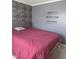 Inviting bedroom with a motivational wall decor and neutral stone accent wall at 10523 Dark Star Dr, Indianapolis, IN 46234