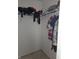 A closet with a variety of clothing items hanging on a metal rod and shelf at 10523 Dark Star Dr, Indianapolis, IN 46234