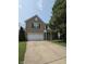 Charming two-story brick home with a two-car garage and landscaped front yard at 10523 Dark Star Dr, Indianapolis, IN 46234