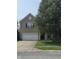 Two-story brick home with a front porch and attached garage, set on a sunny lot at 10523 Dark Star Dr, Indianapolis, IN 46234