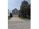 Traditional brick home with a well-maintained lawn and mature shade tree in front at 10523 Dark Star Dr, Indianapolis, IN 46234