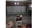 View of a garage with exposed beams and concrete floors for parking and storage at 10523 Dark Star Dr, Indianapolis, IN 46234