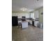 A kitchen with white cabinets, black appliances, tile floors, and center island at 10523 Dark Star Dr, Indianapolis, IN 46234