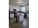 A kitchen with white cabinets, island with stools, black appliances, and a brick backsplash at 10523 Dark Star Dr, Indianapolis, IN 46234