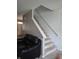 Carpeted staircase with white railings adjacent to a comfortable leather couch at 10523 Dark Star Dr, Indianapolis, IN 46234