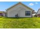 Home's backyard featuring lush green grass and well-maintained exterior at 10938 E Mount Vernon N Trl, Indianapolis, IN 46229