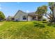 Home's backyard featuring lush green grass, mature tree, and a well-maintained lawn at 10938 E Mount Vernon N Trl, Indianapolis, IN 46229